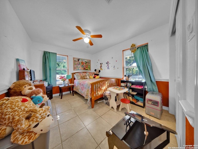 tiled bedroom featuring ceiling fan