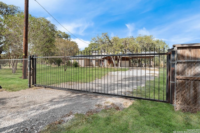 view of gate featuring a yard