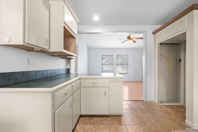 kitchen featuring ceiling fan, white cabinetry, kitchen peninsula, and light tile patterned floors