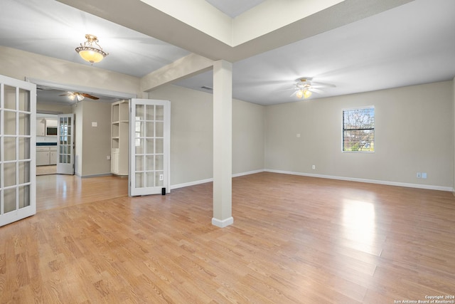 unfurnished room with ceiling fan, light hardwood / wood-style floors, and french doors