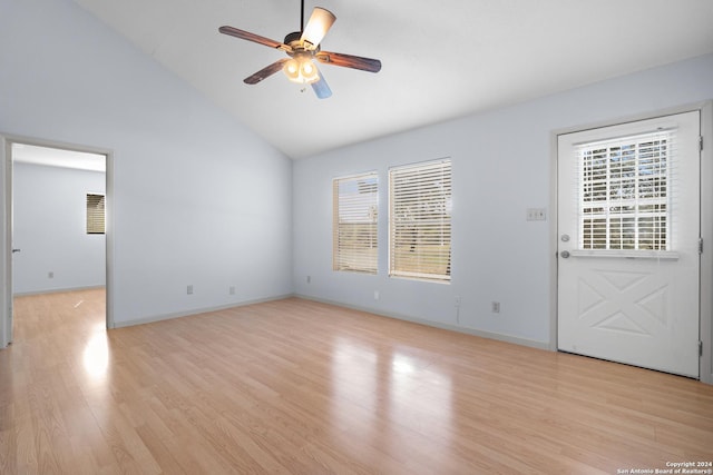 unfurnished room with ceiling fan, plenty of natural light, high vaulted ceiling, and light wood-type flooring