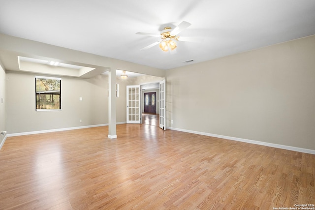 spare room with ceiling fan, light wood-type flooring, and french doors