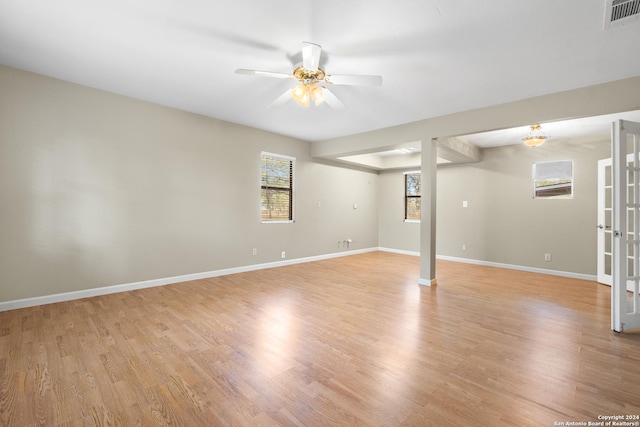 basement featuring ceiling fan and light wood-type flooring