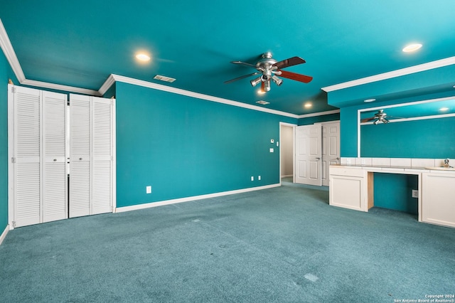 unfurnished bedroom featuring carpet flooring, ceiling fan, sink, and ornamental molding