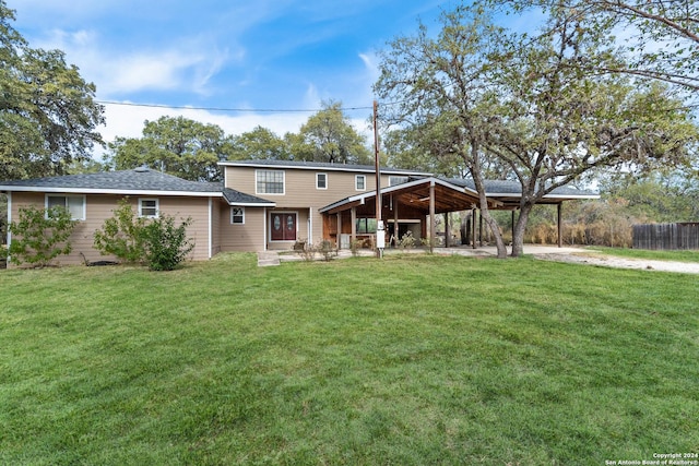 rear view of property with a lawn