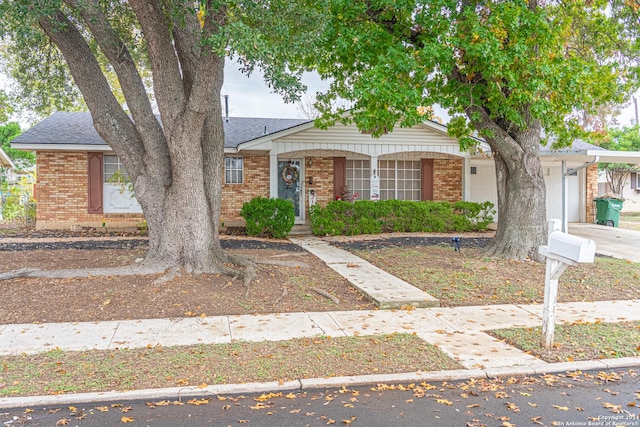 view of front of home featuring a porch and a garage