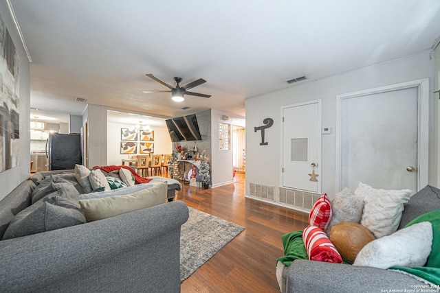 living room with dark hardwood / wood-style floors and ceiling fan