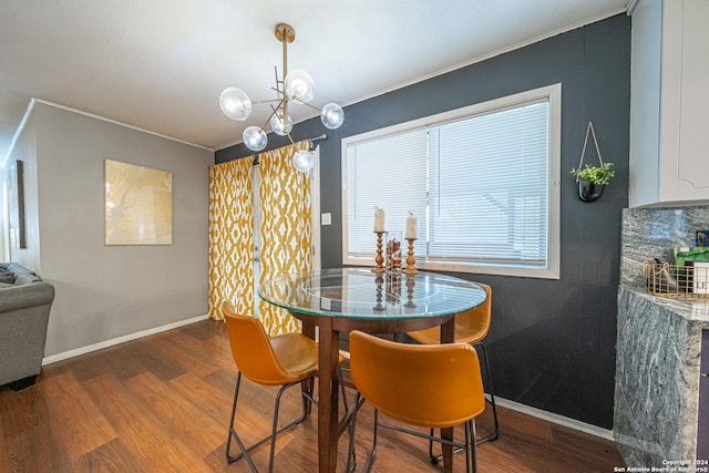 dining room with an inviting chandelier, ornamental molding, and hardwood / wood-style flooring