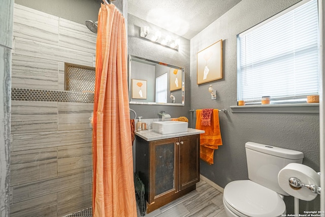 bathroom featuring a shower with curtain, a textured ceiling, toilet, vanity, and hardwood / wood-style flooring