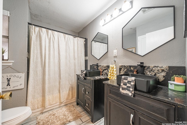 full bathroom with hardwood / wood-style floors, vanity, toilet, and shower / tub combo