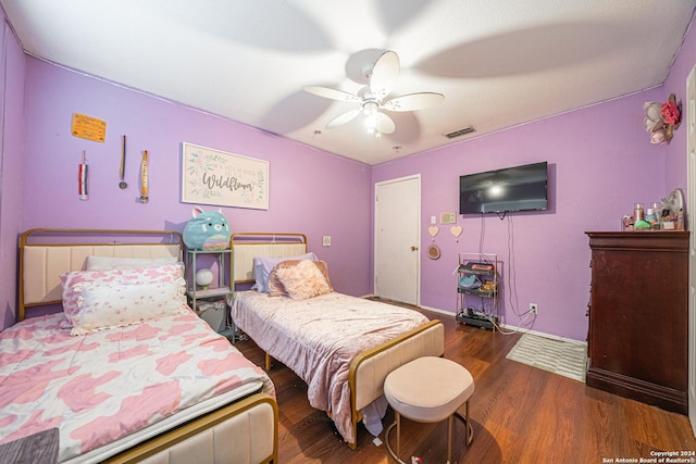 bedroom with ceiling fan and dark hardwood / wood-style floors