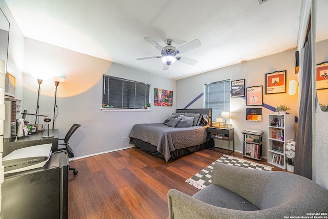 bedroom with ceiling fan and dark hardwood / wood-style flooring