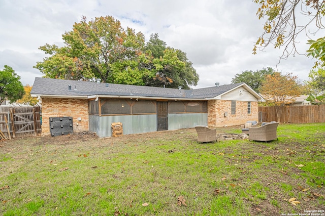 rear view of house featuring central air condition unit, a yard, and an outdoor hangout area