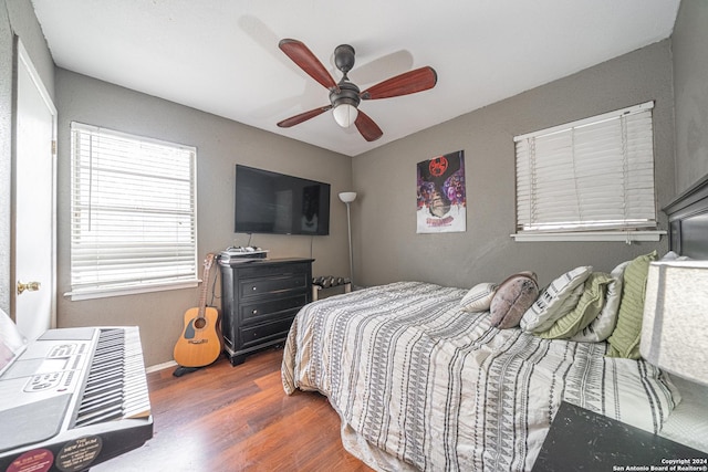 bedroom featuring dark hardwood / wood-style flooring and ceiling fan