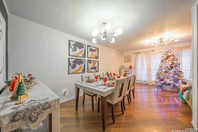 dining space featuring a textured ceiling, a chandelier, and dark hardwood / wood-style floors