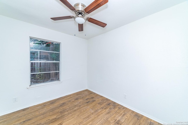 spare room with ceiling fan, plenty of natural light, and hardwood / wood-style floors