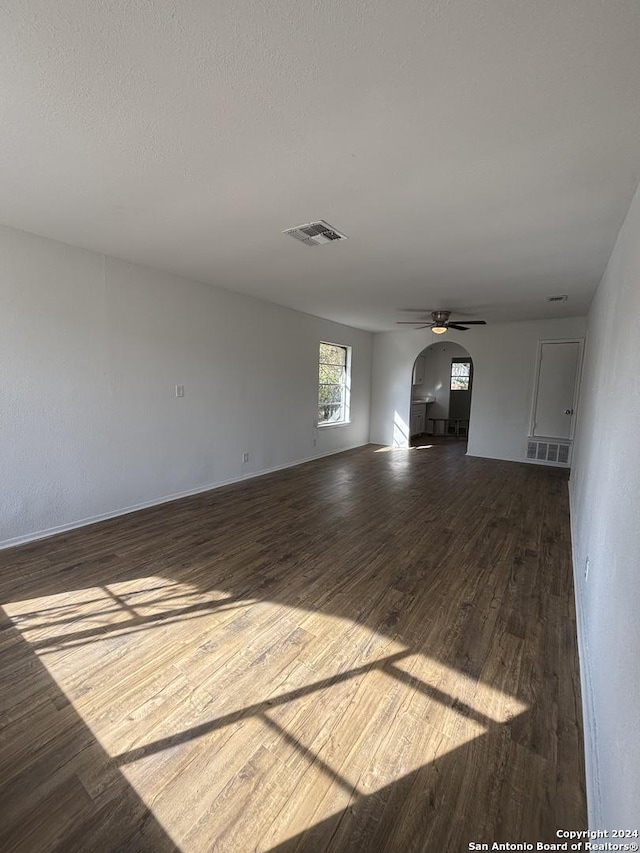 unfurnished living room featuring hardwood / wood-style flooring and ceiling fan