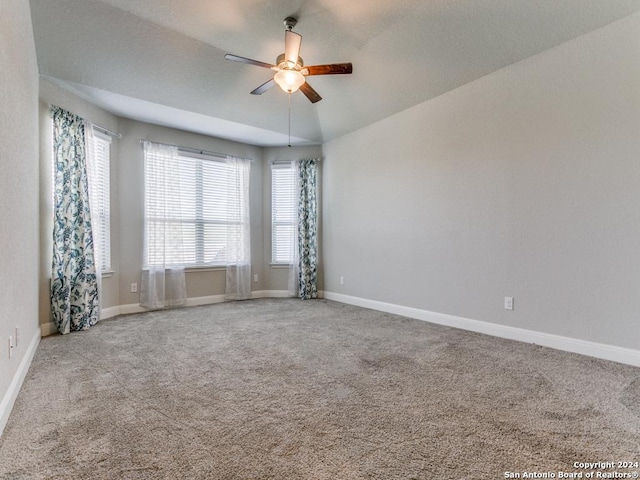 spare room featuring ceiling fan, carpet floors, and lofted ceiling