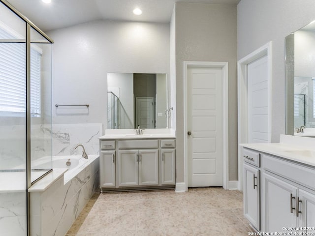 bathroom with tile patterned flooring, vanity, lofted ceiling, and plus walk in shower