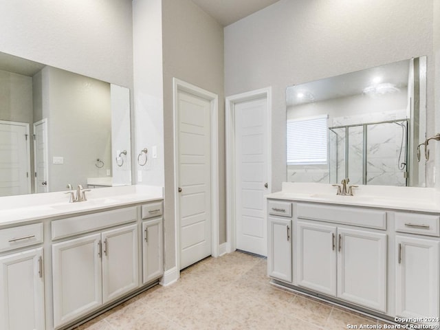 bathroom featuring vanity and an enclosed shower