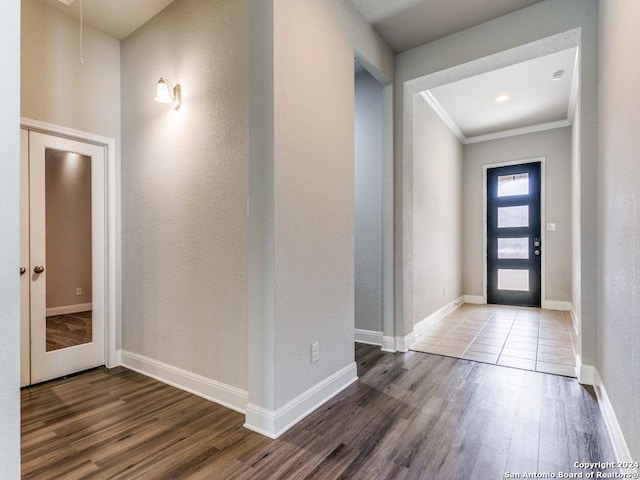 entryway with dark hardwood / wood-style floors and ornamental molding