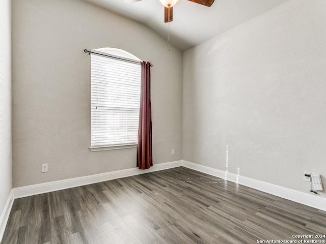 empty room featuring ceiling fan, dark hardwood / wood-style flooring, and lofted ceiling