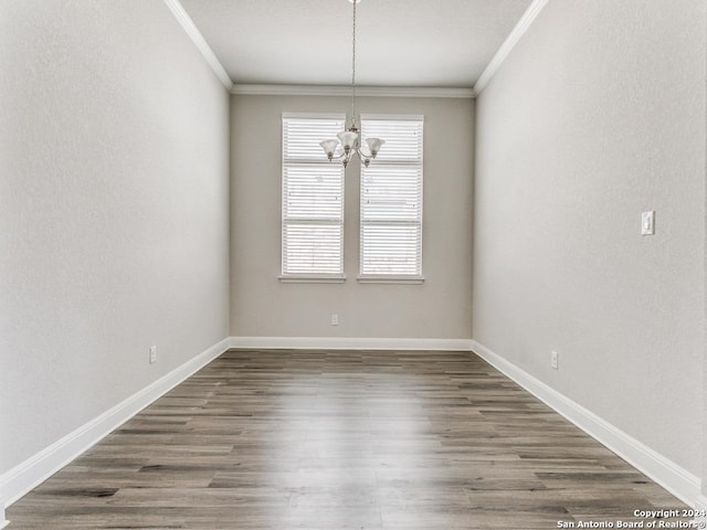 unfurnished room with ornamental molding, dark hardwood / wood-style flooring, and a notable chandelier