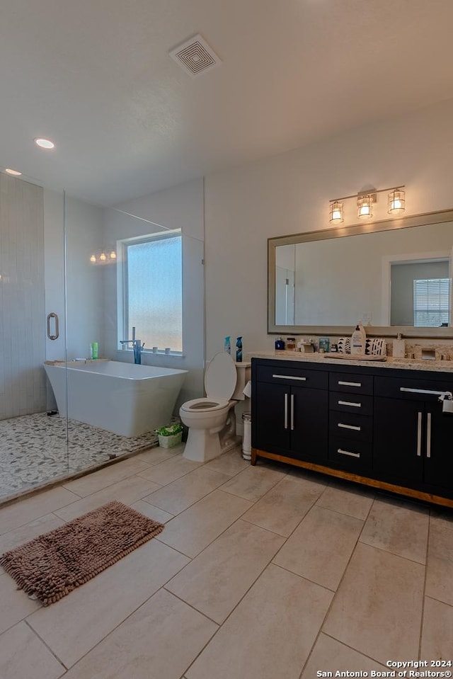 full bathroom with tile patterned flooring, shower with separate bathtub, vanity, and toilet