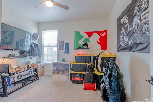 interior space featuring ceiling fan and carpet