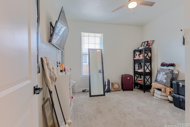 interior space featuring light colored carpet and ceiling fan