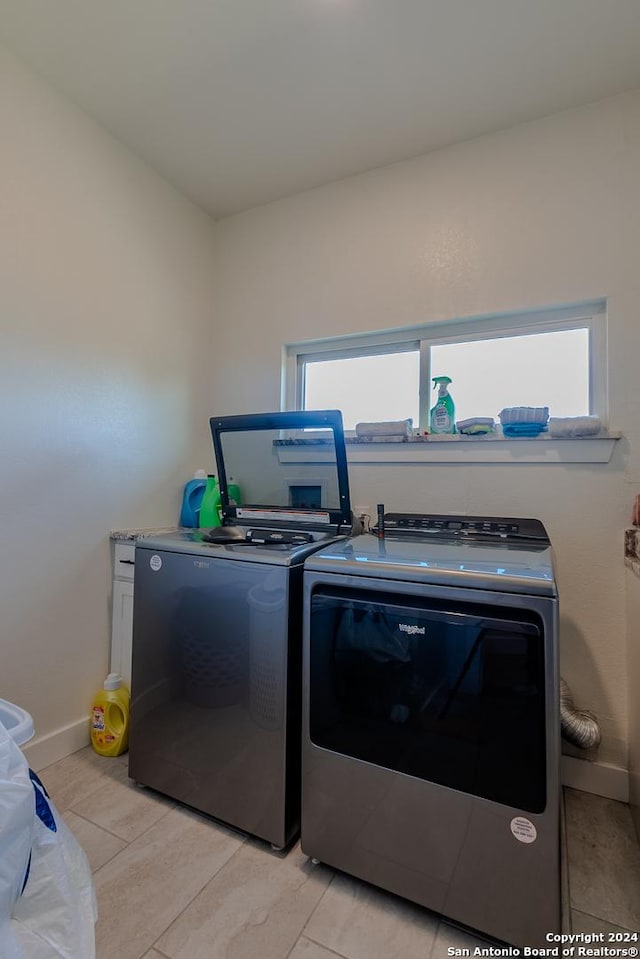 laundry area with washing machine and dryer and a wealth of natural light