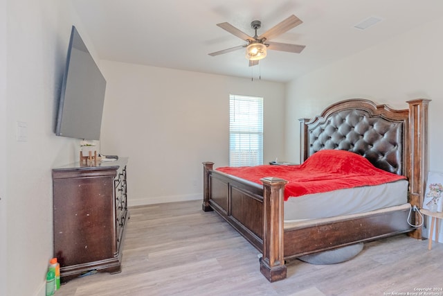 bedroom with ceiling fan and light wood-type flooring