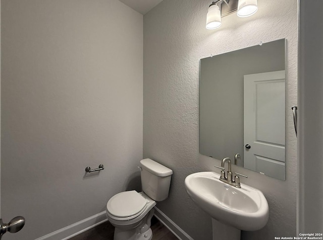 bathroom featuring toilet and sink