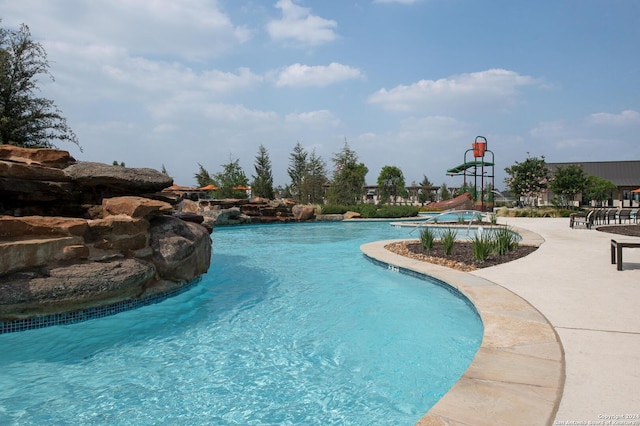 view of pool with a water slide