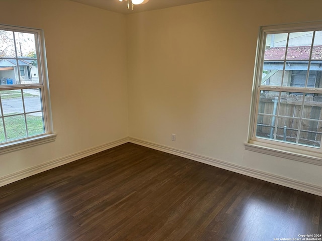 spare room with dark hardwood / wood-style floors