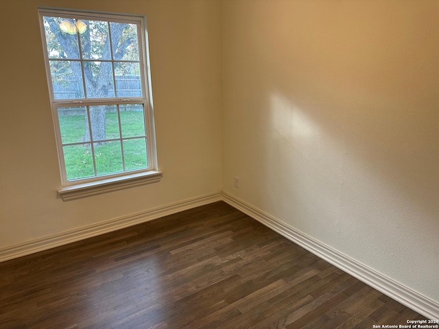 unfurnished room featuring dark hardwood / wood-style flooring