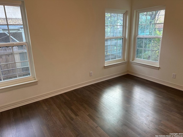 spare room with dark hardwood / wood-style flooring