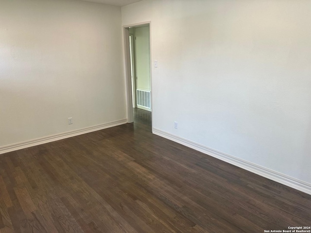 spare room featuring dark hardwood / wood-style flooring