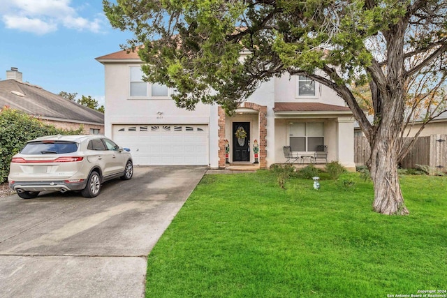 view of front facade featuring a front yard and a garage