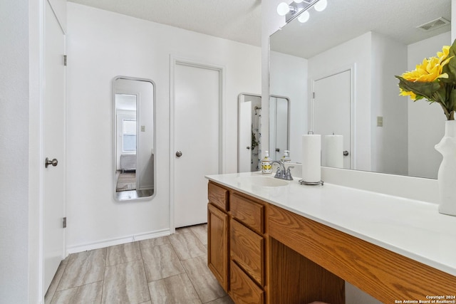 bathroom with visible vents and vanity