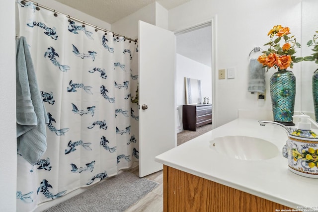 full bath with curtained shower, vanity, and tile patterned floors