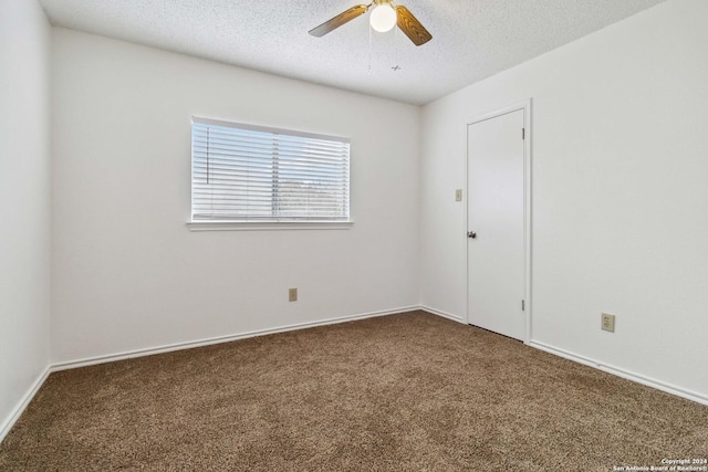 empty room with a textured ceiling, a ceiling fan, and carpet flooring