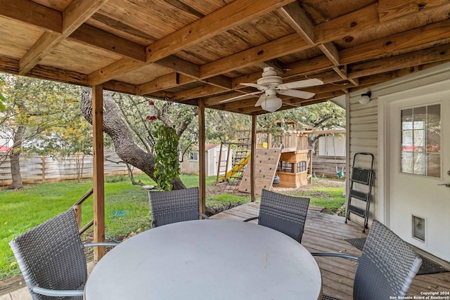 view of patio / terrace with an outbuilding, outdoor dining area, a ceiling fan, a shed, and a fenced backyard