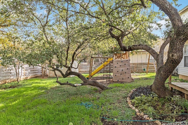 view of yard featuring a fenced backyard and a playground