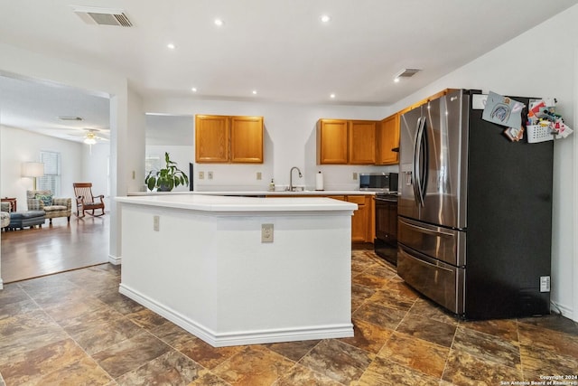 kitchen featuring dark hardwood / wood-style flooring, stainless steel appliances, ceiling fan, sink, and a kitchen island