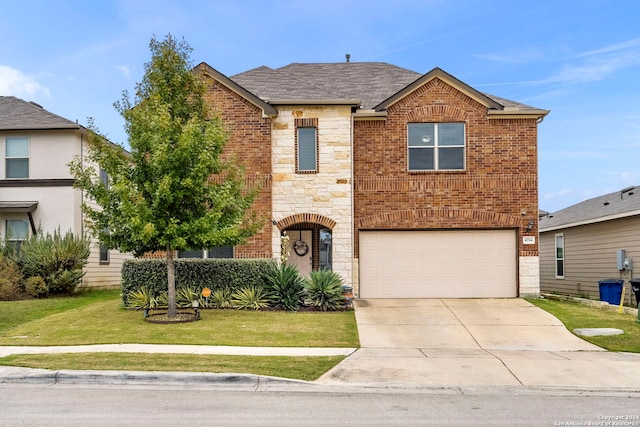 view of property featuring a front yard and a garage