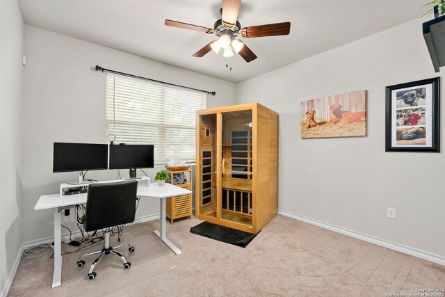 carpeted office space featuring ceiling fan