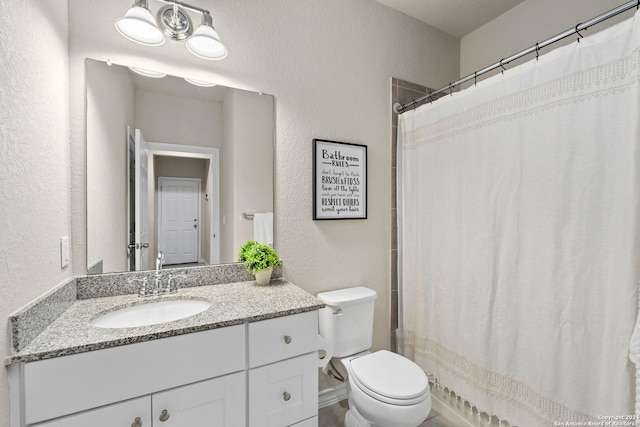 bathroom with vanity, toilet, and curtained shower