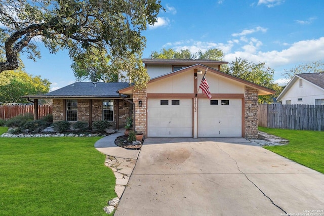 front of property featuring a front yard and a garage