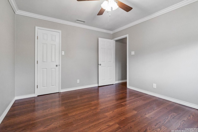 unfurnished room featuring dark hardwood / wood-style floors, ceiling fan, and crown molding